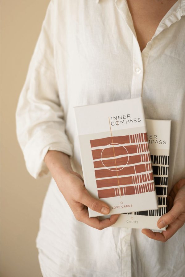 Neel van Lierop holds the Inner Compass Original and Love cards