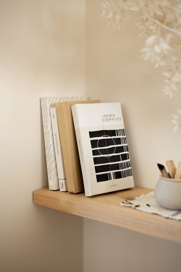 Inner Compass Cards on a shelve with other books